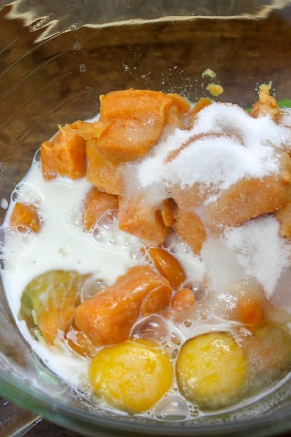 Picture of milk, sugar, eggs, and yams in a bowl