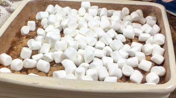 Picture of marshmallows on top of a sweet potato casserole. 