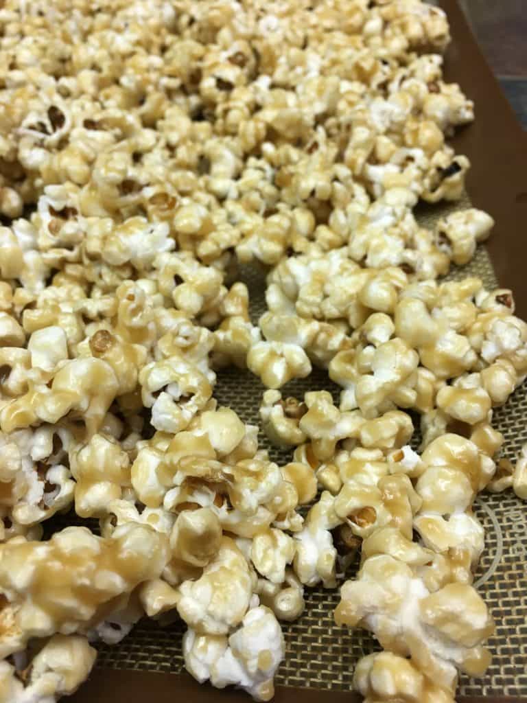 Homemade Salted Caramel Popcorn is a great snack for football parties, Valentine's Day gifts, teacher gifts, and just plain ole' good snacks.