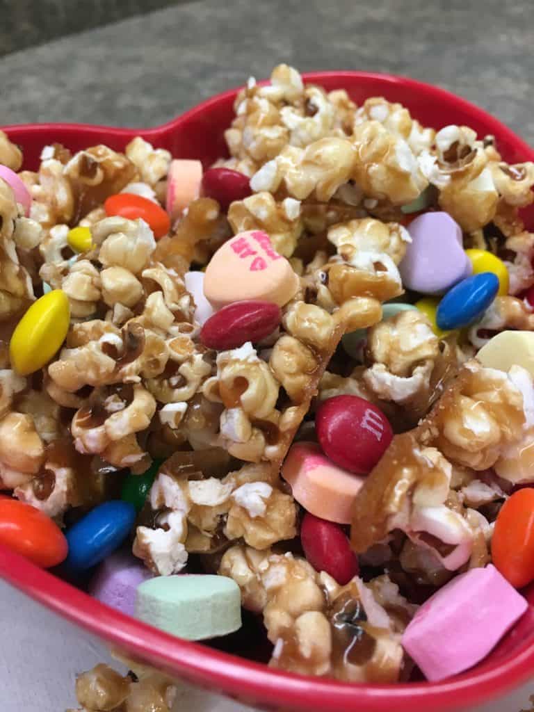 Homemade Salted Caramel Popcorn is a great snack for football parties, Valentine's Day gifts, teacher gifts, and just plain ole' good snacks.