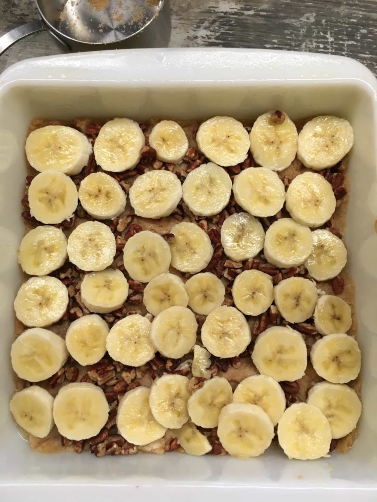 Bananas, brown sugar, and pecans in a casserole dish.