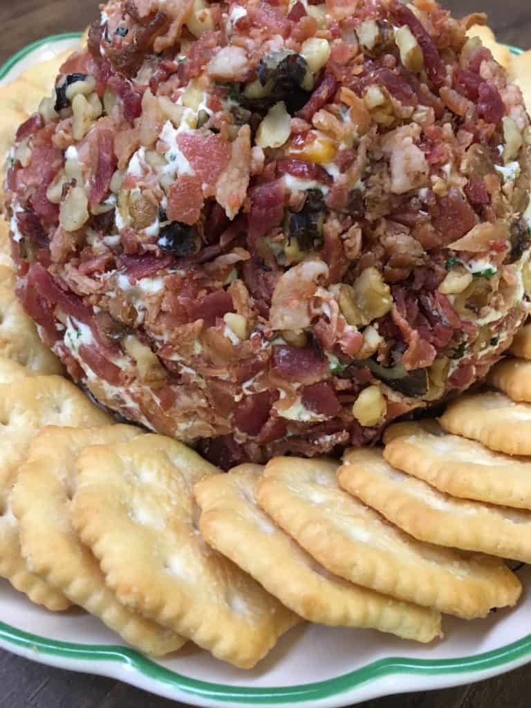 Easy Holiday Bacon Ranch and Walnut Cheeseball is a classic holiday appetizer. The cheeseball is the perfect food to bring to any party. I use pre made real bacon to make it quick and get it ready to eat.