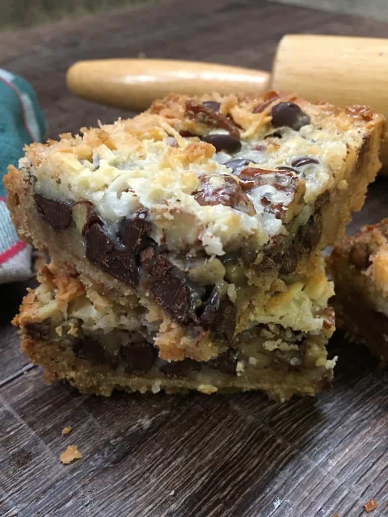 Hello Dolly Bars are one of the best and most delicious desserts that are easy and fun to make. They are a great holiday Christmas treat to take to parties, and share with friends. The combination of chocolate, coconut, chopped pecans, graham crackers, and sweetened condensed milk is going to have everyone lining up to grab one. Hello Dolly Recipe Eagle Brand