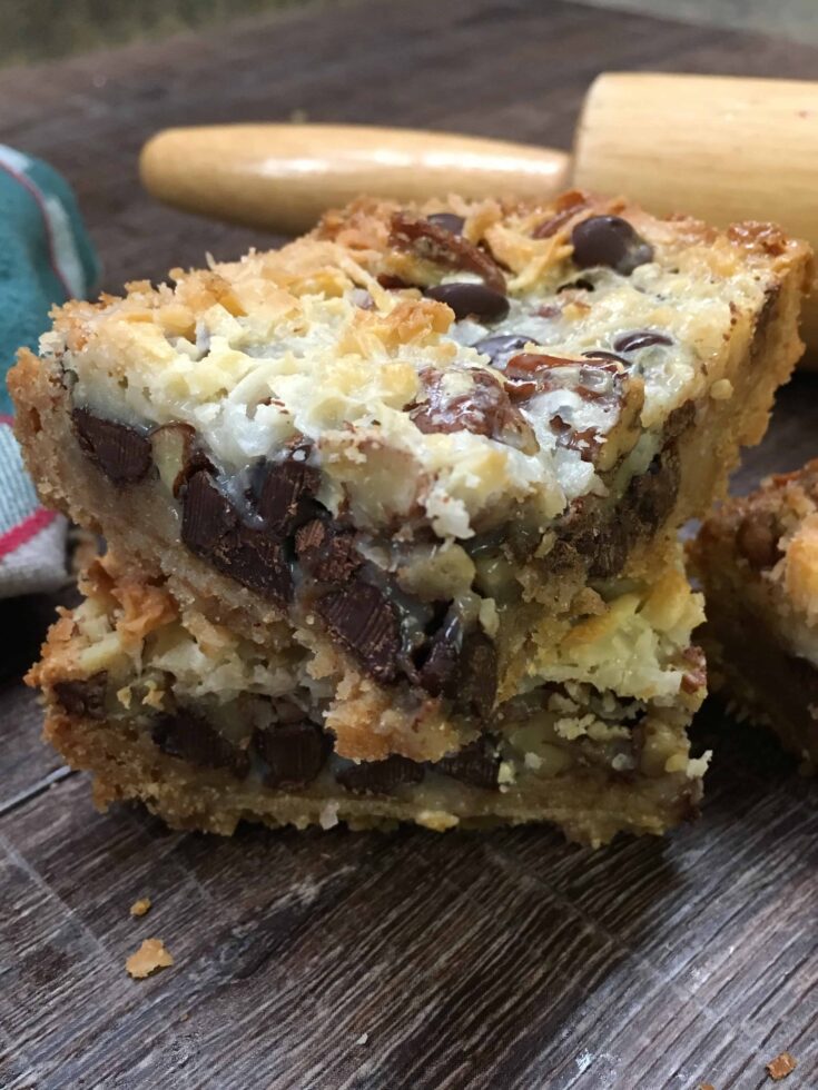 Hello Dolly Bars are one of the best and most delicious desserts that are easy and fun to make. They are a great holiday Christmas treat to take to parties, and share with friends. The combination of chocolate, coconut, chopped pecans, graham crackers, and sweetened condensed milk is going to have everyone lining up to grab one.