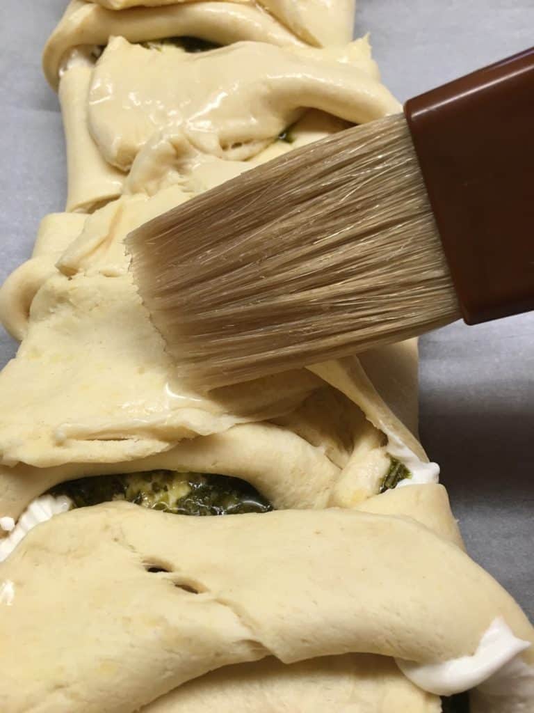 The Cream Cheese Pesto Crescent Roll Braid is a delicious appetizer to make for parties. 