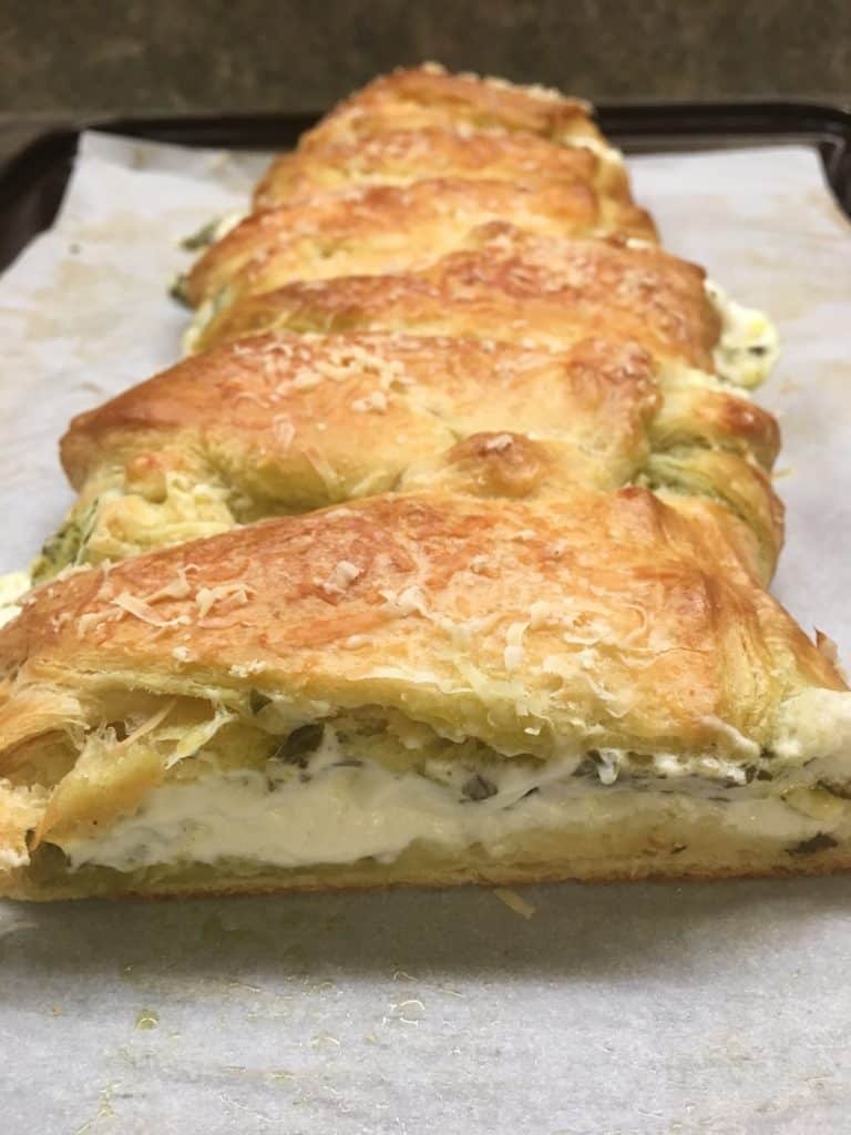 The Cream Cheese Pesto Crescent Roll Braid is a delicious appetizer to make for parties. 