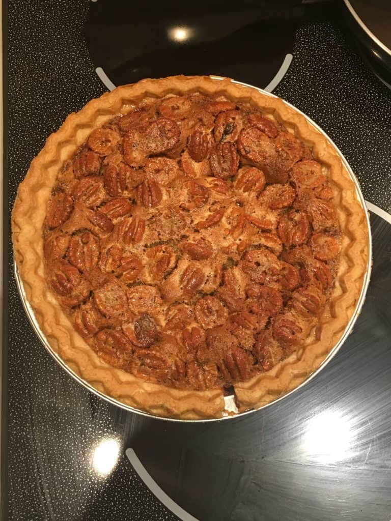 Baked pecan pie sitting on a stovetop