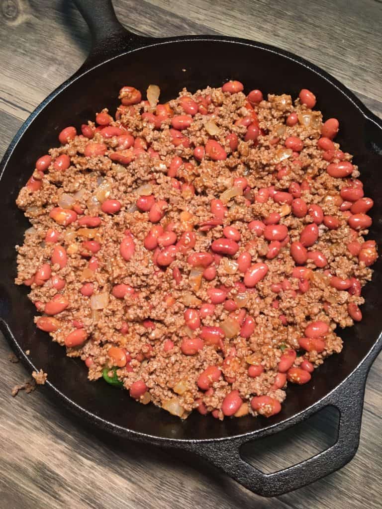 Easy Chili Cornbread Skillet is a tasty meal that won't break the bank, but will leave everyone full and satisfied. The chili cornbread skillet is a great meal to fix for tailgating parties, a quick supper, or to freeze and thaw out later when you're in a hurry. If you're watching your waistline, you can use lean ground beef, or ground turkey.