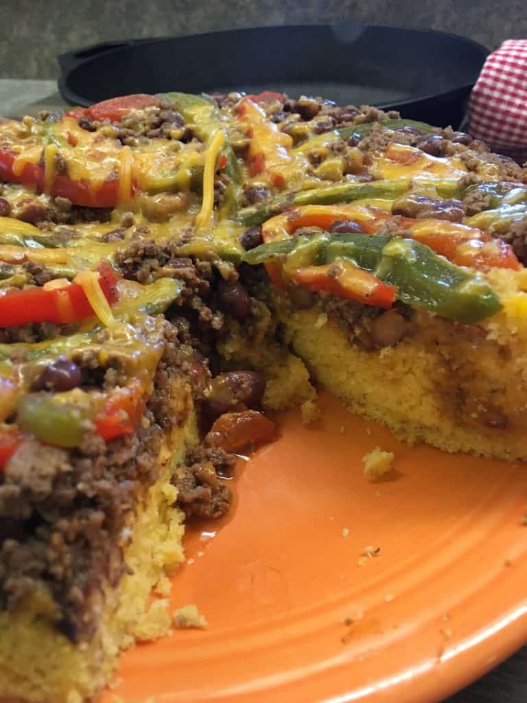 Easy Chili Cornbread Skillet is a tasty meal that won't break the bank, but will leave everyone full and satisfied. The chili cornbread skillet is a great meal to fix for tailgating parties, a quick supper, or to freeze and thaw out later when you're in a hurry. If you're watching your waistline, you can use lean ground beef, or ground turkey.