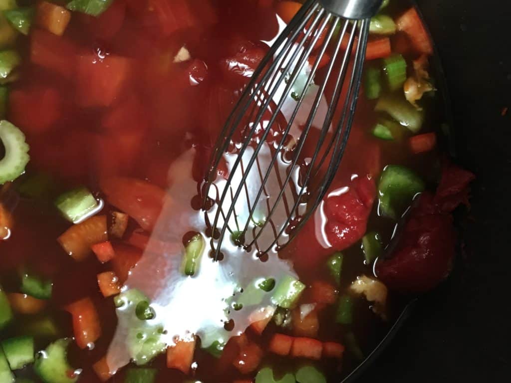 Mixing the vegetables in the saucepan. 