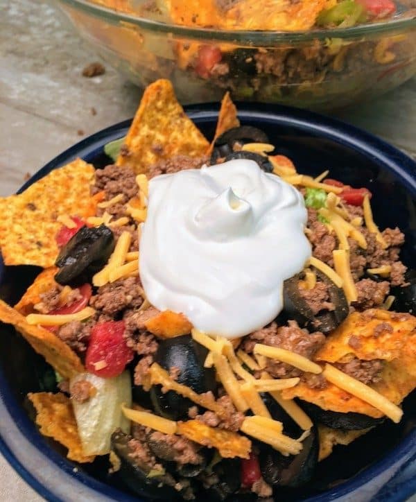 Easy Dorito Taco Salad Recipe is a cinch to make. It features spicy taco flavors that will please a crowd. Easy Dorito Taco Salad is perfect for a family supper, a tailgating party, football games, or any holiday. #dorito #taco #salad #supper #dinner