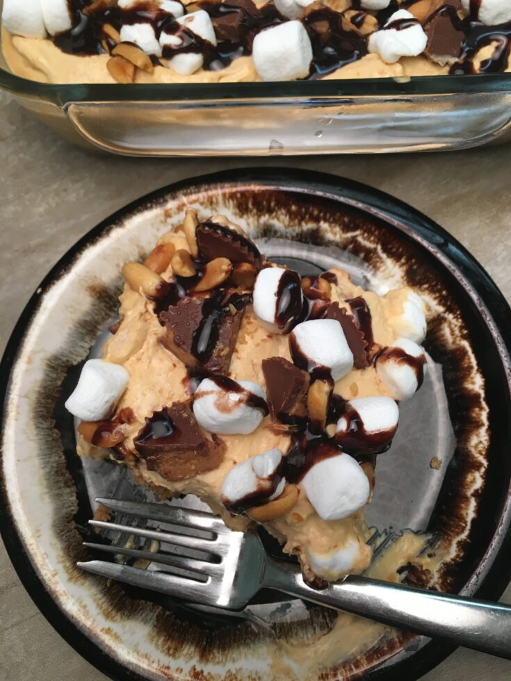 Reese's peanut butter dessert on a plate with a fork.