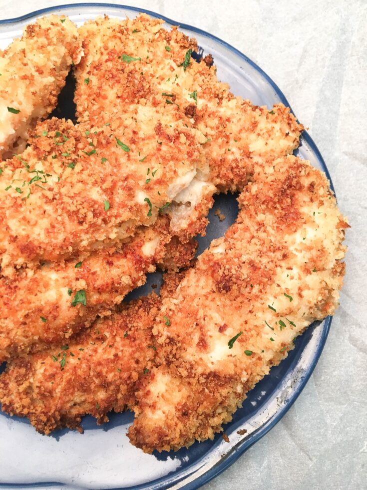 Baked Buttermilk Chicken Strips are a budget-friendly homemade dinner that is easy to make. The oven-baked chicken strips are breaded in buttermilk, parmesan cheese, herbs, and Panko bread crumbs for a delicious and tasty dinner.