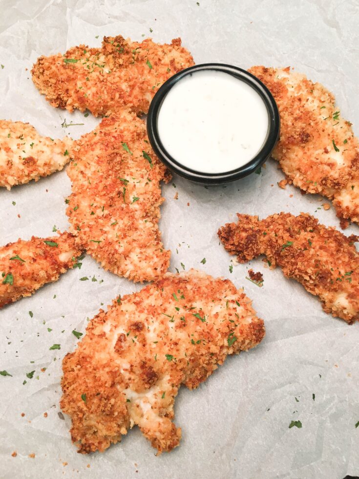 Baked Buttermilk Chicken Strips are a budget-friendly homemade dinner that is easy to make. The oven-baked chicken strips are breaded in buttermilk, parmesan cheese, herbs, and panko bread crumbs for a delicious and tasty dinner.