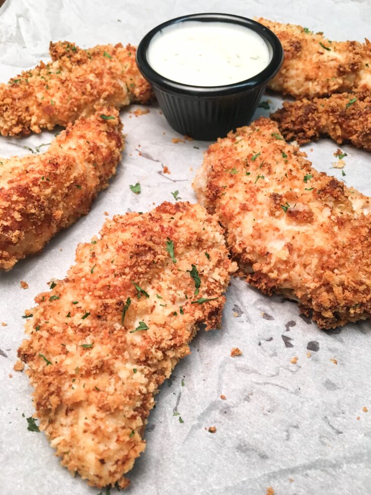 Baked Buttermilk Chicken Strips are a budget-friendly homemade dinner that is easy to make. The oven-baked chicken strips are breaded in buttermilk, parmesan cheese, herbs, and panko bread crumbs for a delicious and tasty dinner.