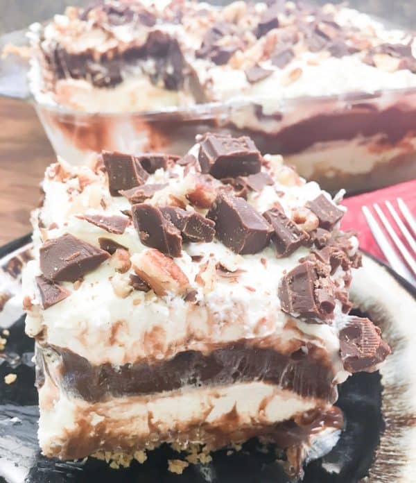 Chocolate layer dessert with a graham cracker crust, homemade whipped cream, chocolate pudding, and cream cheese is a delicious recipe. The easy recipe is the perfect dish for a party, the holidays, or for dessert at home.