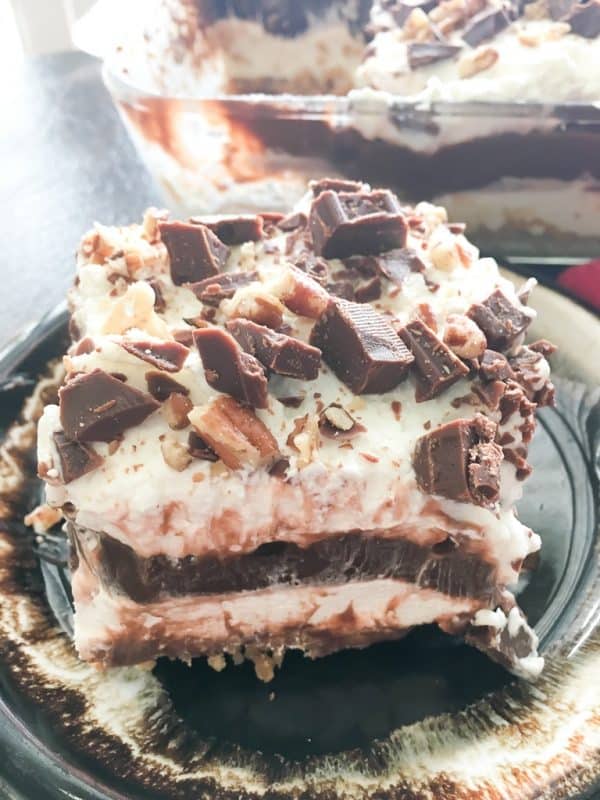 Chocolate layer dessert with a graham cracker crust, homemade whipped cream, chocolate pudding, and cream cheese is a delicious recipe. The easy recipe is the perfect dish for a party, the holidays, or for dessert at home.