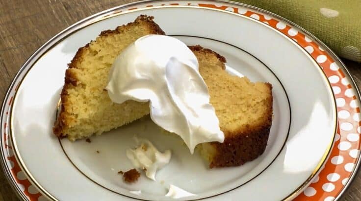 Pound cake on a plate with whipped cream on top