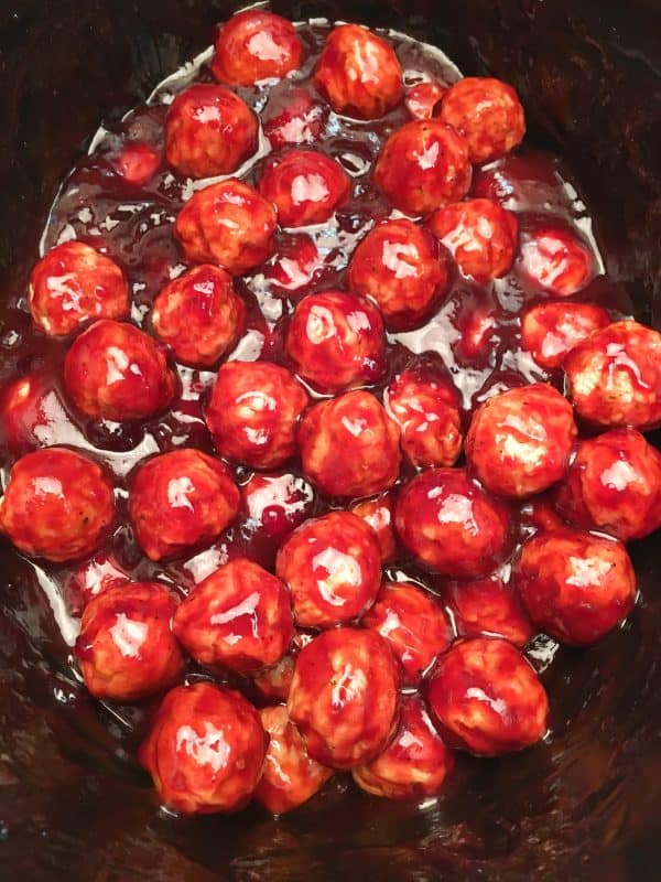 Easy Crock Pot Meatball Recipe is made up of frozen meatballs, barbecue and grape jelly. The dish makes a great dinner or an appetizer for church or a party, and is easy to make.