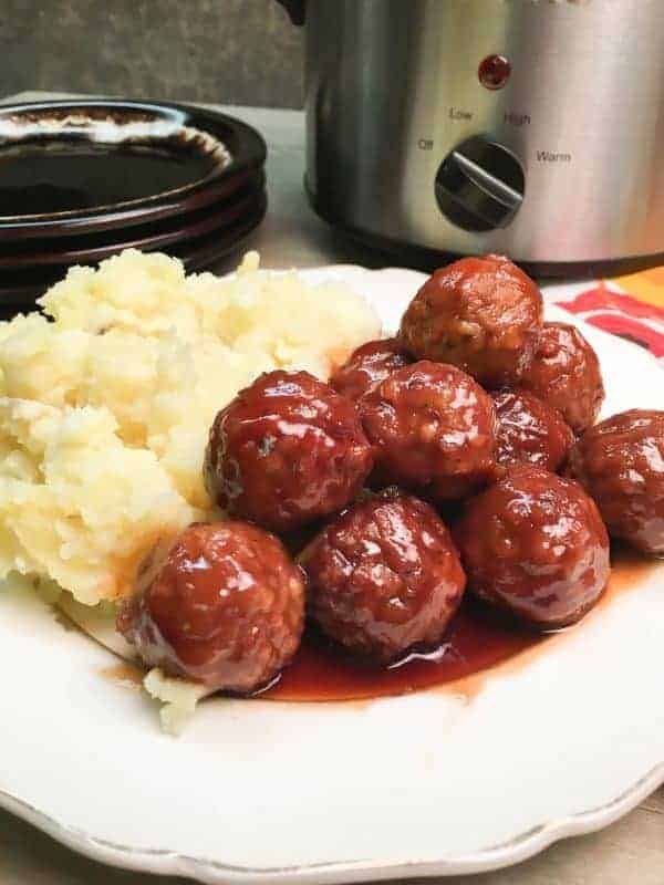 Easy Crock Pot Meatball Recipe is made up of frozen meatballs, barbecue and grape jelly. The dish makes a great dinner or an appetizer for church or a party, and is easy to make.