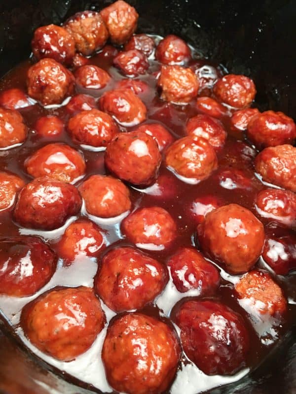 Easy Crock Pot Meatball Recipe is made up of frozen meatballs, barbecue and grape jelly. The dish makes a great dinner or an appetizer for church or a party, and is easy to make.