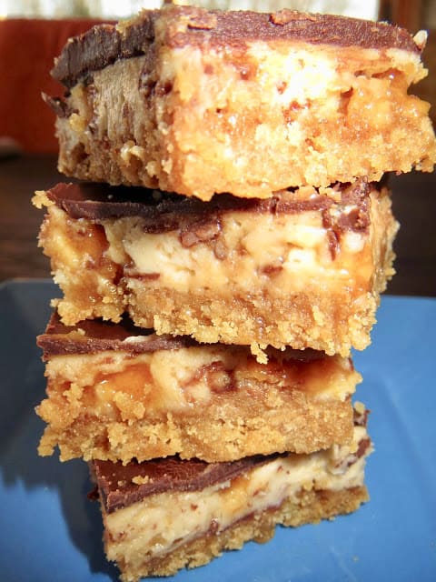 Butterfinger Bliss Bars from Living On Cloud Nine are a combination of Nutter Butter Cookies and Butterfinger Bars. A crust and cheesecake filling make up the recipe. 