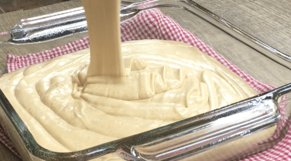 Picture of peanut butter fudge being poured into a glass dish