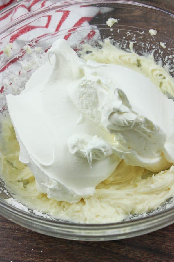 Cream cheese and whipped topping in a glass bowl. 