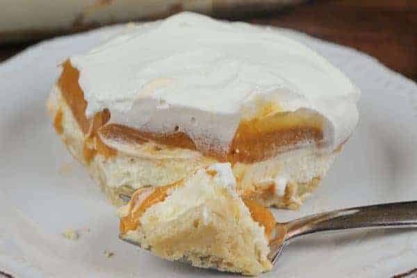 Butterscotch lush dessert on a plate with a fork.