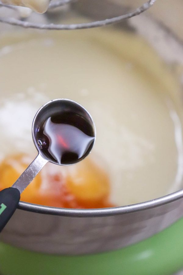 Picture of vanilla being added to a cookie mixture. 