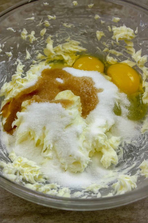 Picture of eggs, butter, sugar, and vanilla in a glass bowl