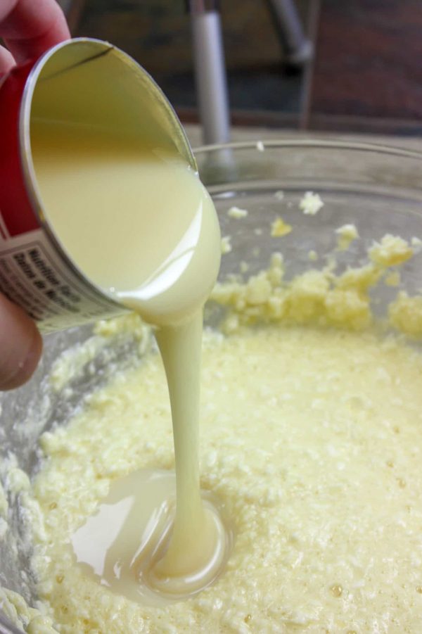 Picture of pouring a can of sweetened condensed milk into a bowl.