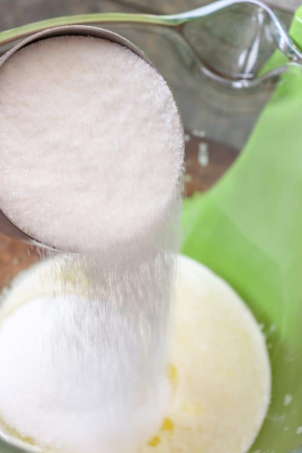 Picture of sugar being poured into a bowl.