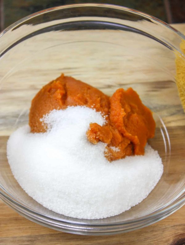 Picture of pumpkin puree and sugar in a glass bowl.