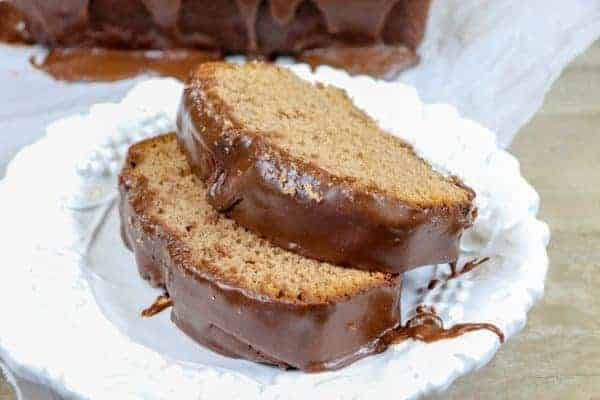 Picture of chocolate pound cake with frosting on a plate.