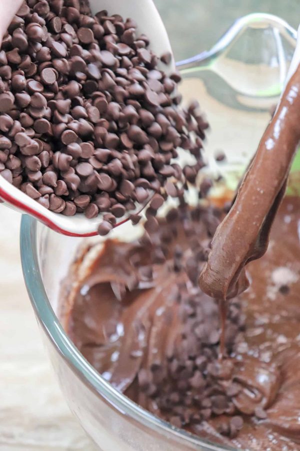 Picture of chocolate chips being poured into a glass bowl.