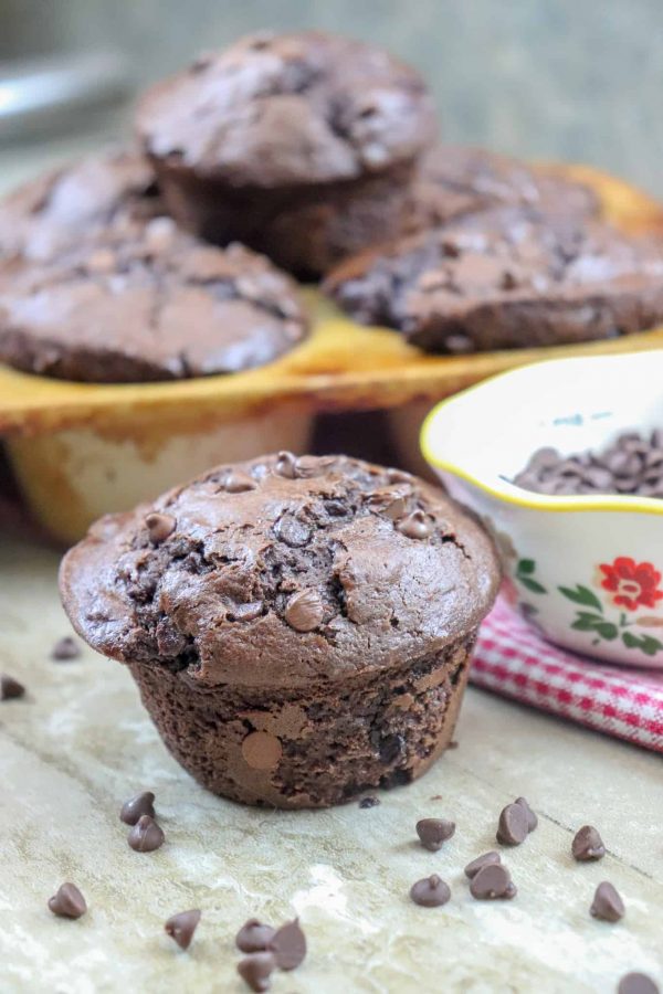 Picture of a muffin on the counter, and muffins in the tin.