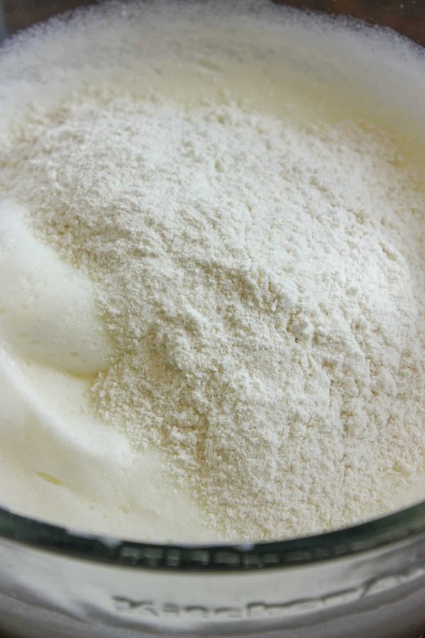 Picture of flour being poured into egg whites for an angel food cake.