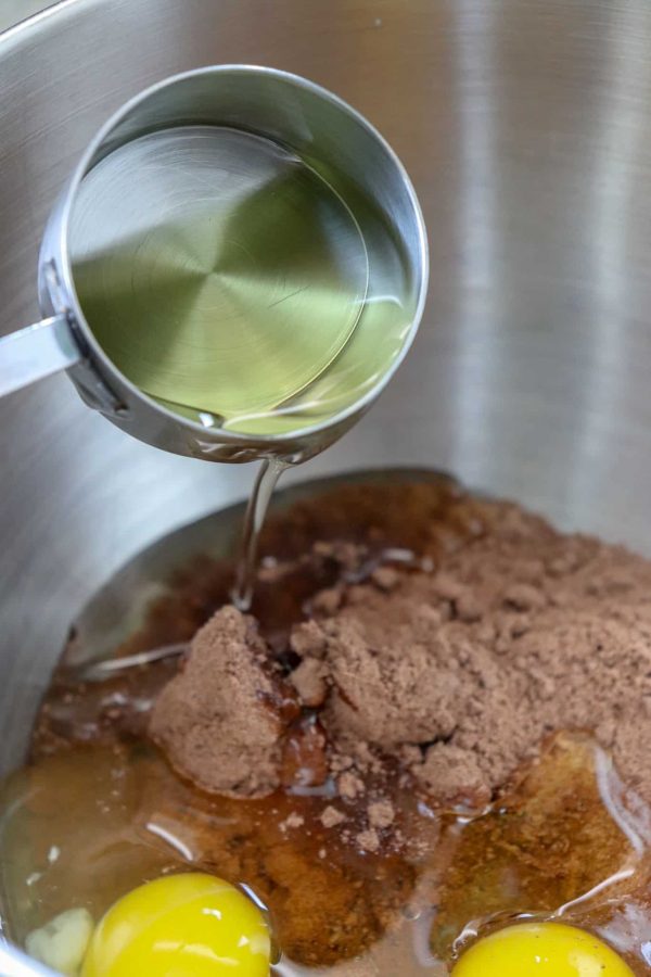 Picture of oil being poured into a cake mix.