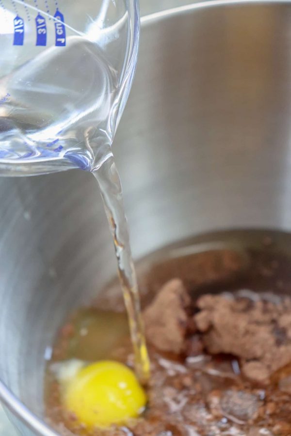 Picture of water being poured into a cake mix.