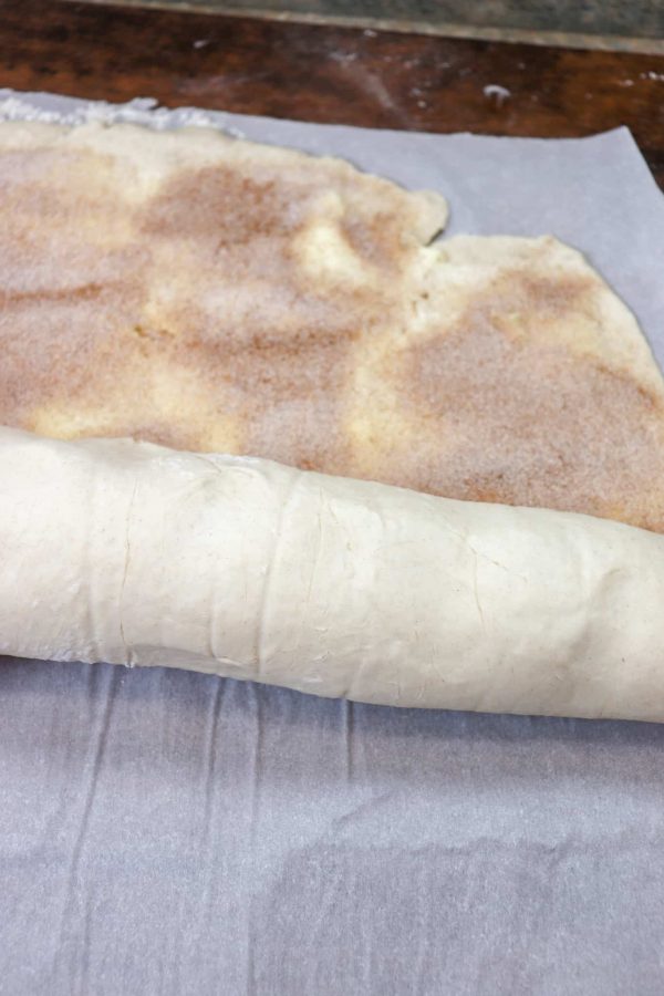 Picture of cinnamon roll dough rolled up.