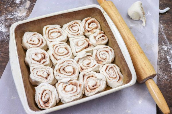 Picture of cinnamon rolls in a greased casserole dish.