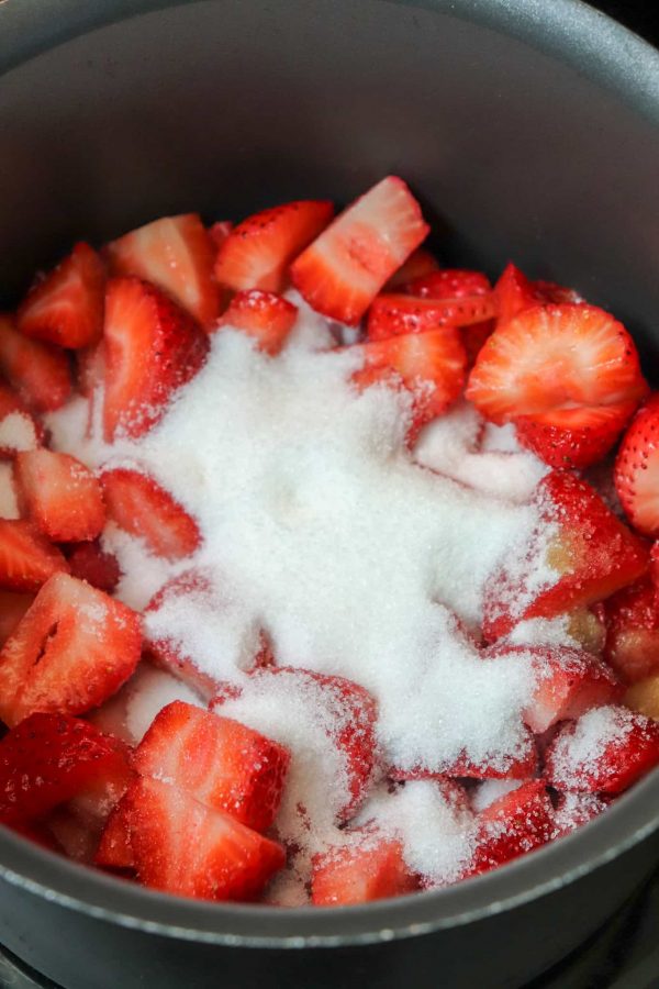 Picture of strawberries and sugar in a saucepan. 