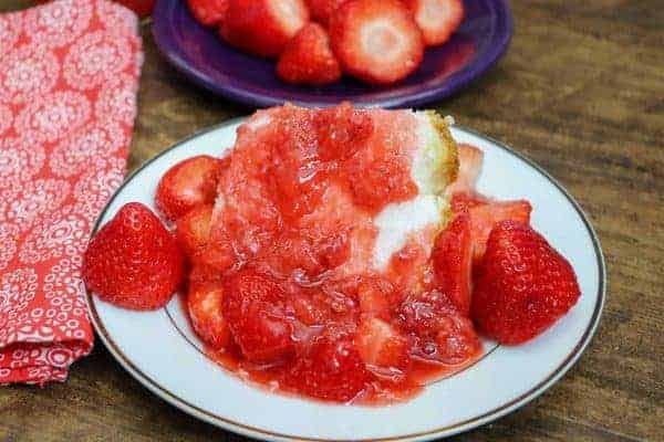 Picture of strawberry syrup on a piece of angel food cake.