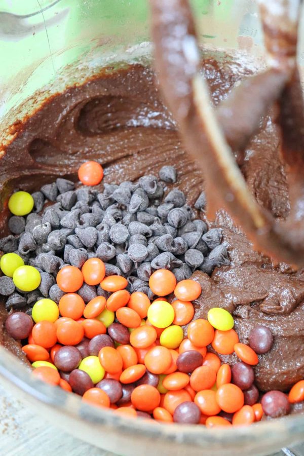 Picture of chocolate chips and Reese's Pieces in a bowl with brownie mix.