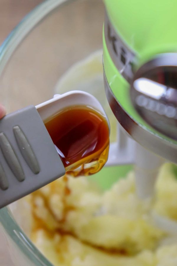 Picture of vanilla being poured into the bowl. 