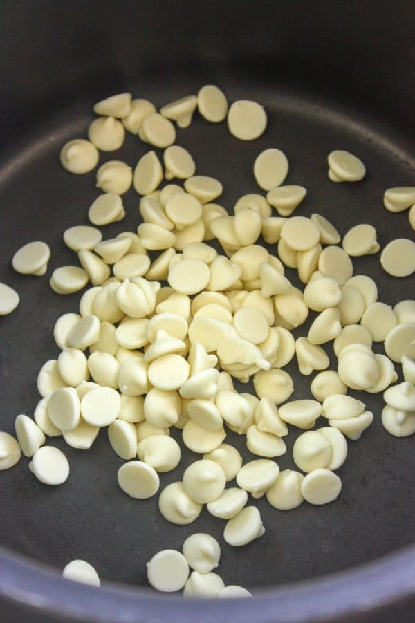 Picture of white chocolate chips in a saucepan.