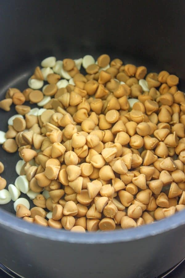 Picture of butterscotch, peanut butter, and white chocolate chips in a saucepan.