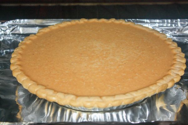 Picture of pumpkin pie in the oven.