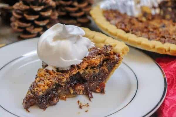 Picture of pecan pie with whipped cream.